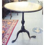 An early 20thC Georgian design mahogany pedestal table with a floral carved border, on a splayed