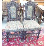 A pair of 1920s Black Forest, Jacobean inspired, carved and stained oak framed hall chairs with