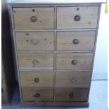 An early 20thC pine dressing chest, having two backs of five short drawers, on a plinth  53"h  38"w