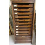 A 1930s oak pedestal filing cabinet with a rise-and-fall tambour front, on a plinth  41"h  18"w