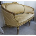 A 20thC French 19thC inspired giltwood, showwood framed, three person settee, upholstered in shell