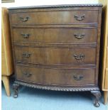 A 1930s mahogany bow front four drawer dressing chest, raised on stubby cabriole legs with shell