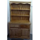 A 20thC pine dresser, the superstructure with two open plate racks, over two drawers and two