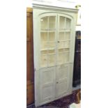 A 20thC shabby chic wash painted, distressed finished oak and pine, two part corner cabinet, the