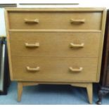A G-Plan light oak three drawer dressing chest, raised on tapered legs  34"h  31"w