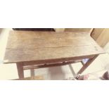 A 19thC rustically constructed pine farmhouse style kitchen table, the three plank top raised on