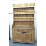 A late 19thC rustically constructed pine two part dresser, the superstructure with two plate