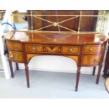 An Edwardian Sheraton Revival period serving sideboard with a lacquered brass gallery upstand,