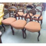 A set of six late Victorian mahogany framed and floral rosette carved bar back dining chairs,