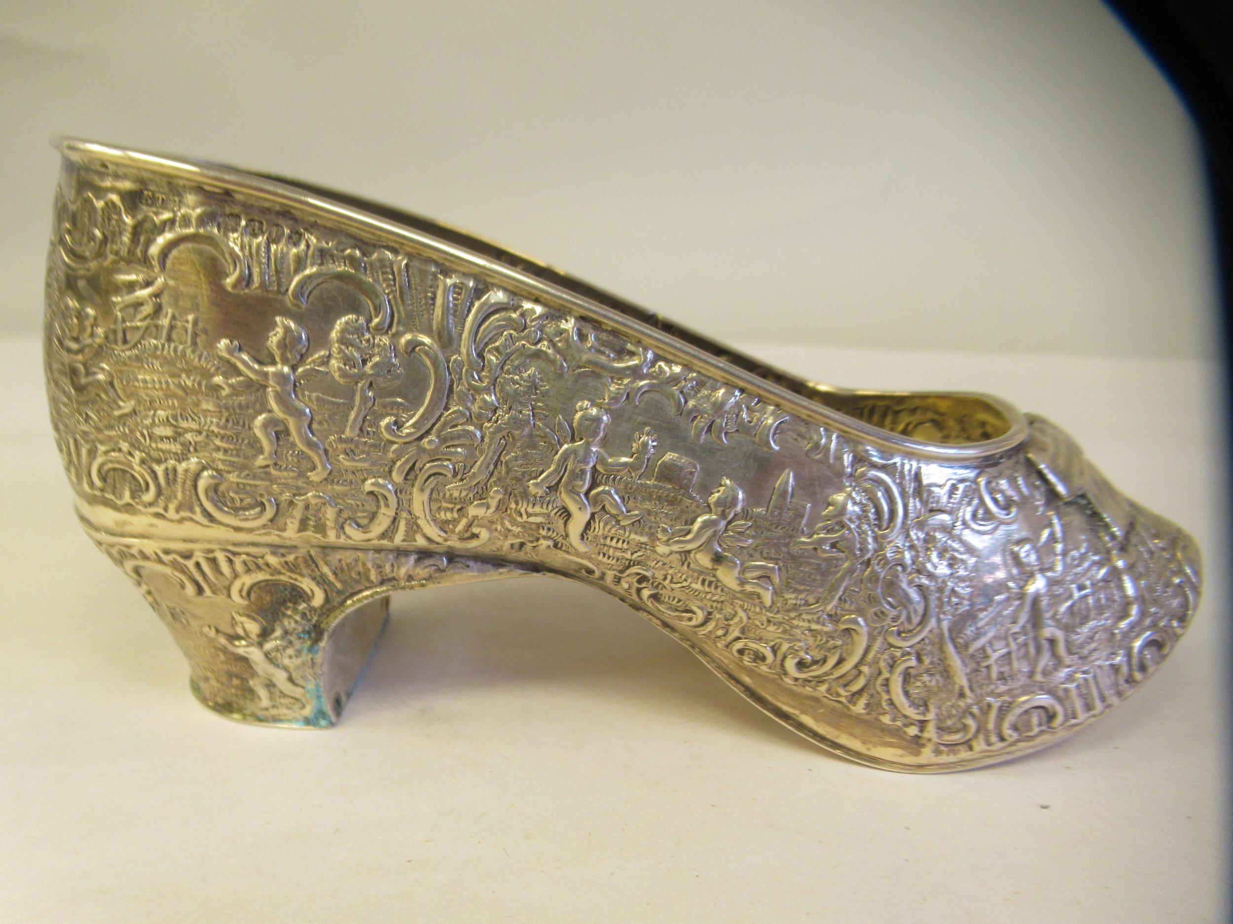 A Dutch silver coloured metal ornament, in the form of a lady's shoe, allover cast and chased with - Image 4 of 6