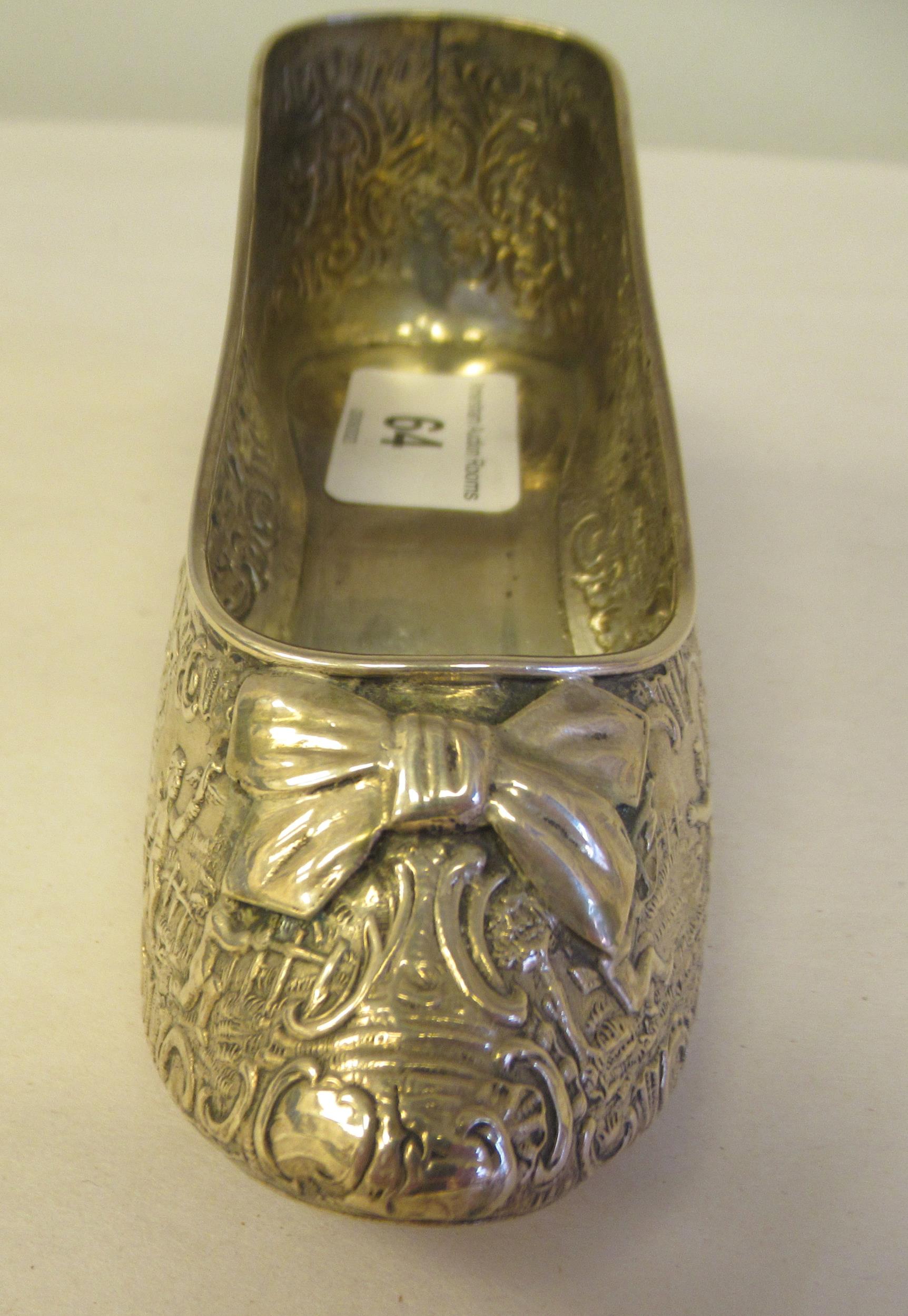 A Dutch silver coloured metal ornament, in the form of a lady's shoe, allover cast and chased with - Image 5 of 6