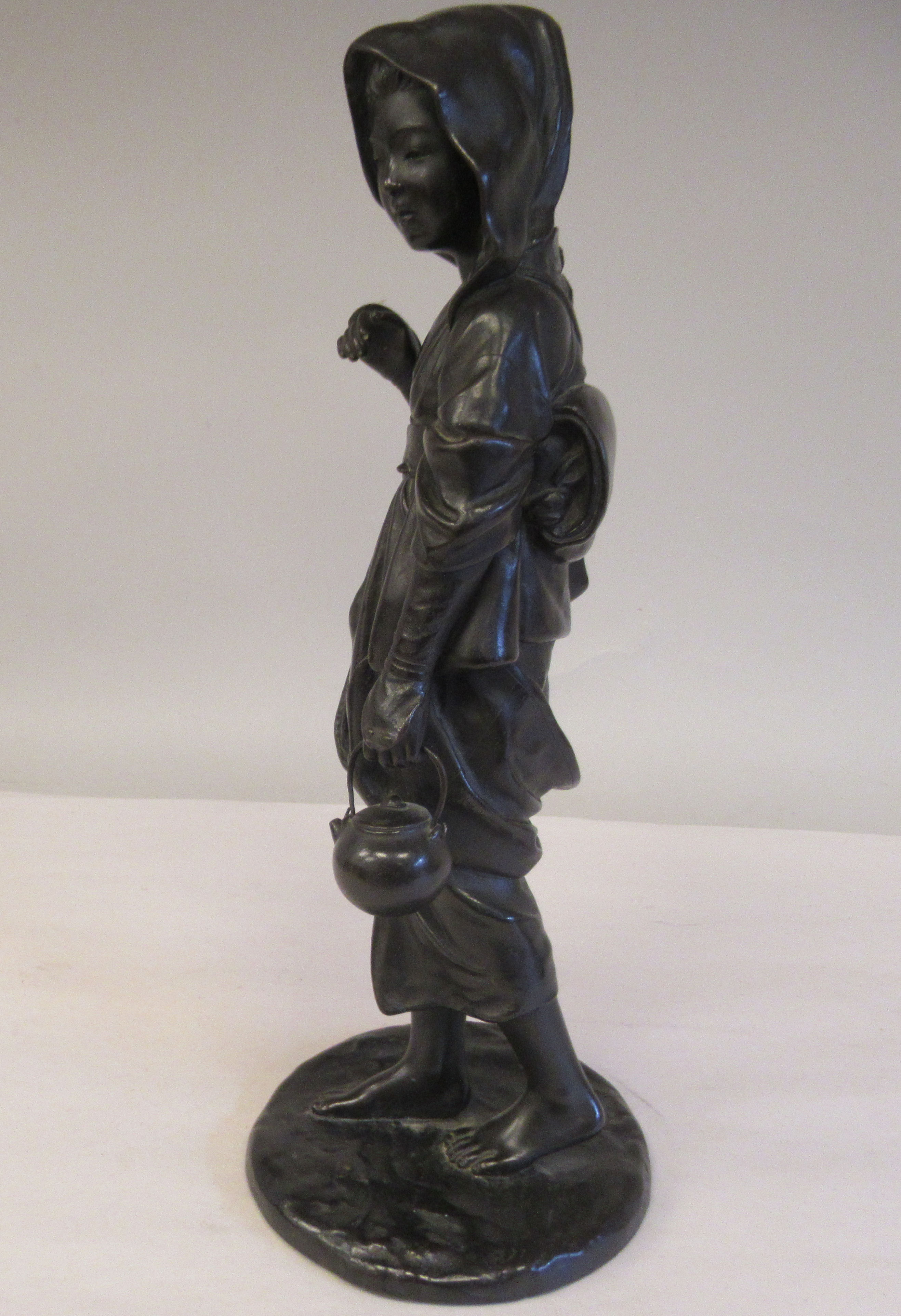 A late 19thC cast and patinated bronze figure, a young woman wearing traditional dress, walking with - Image 3 of 6