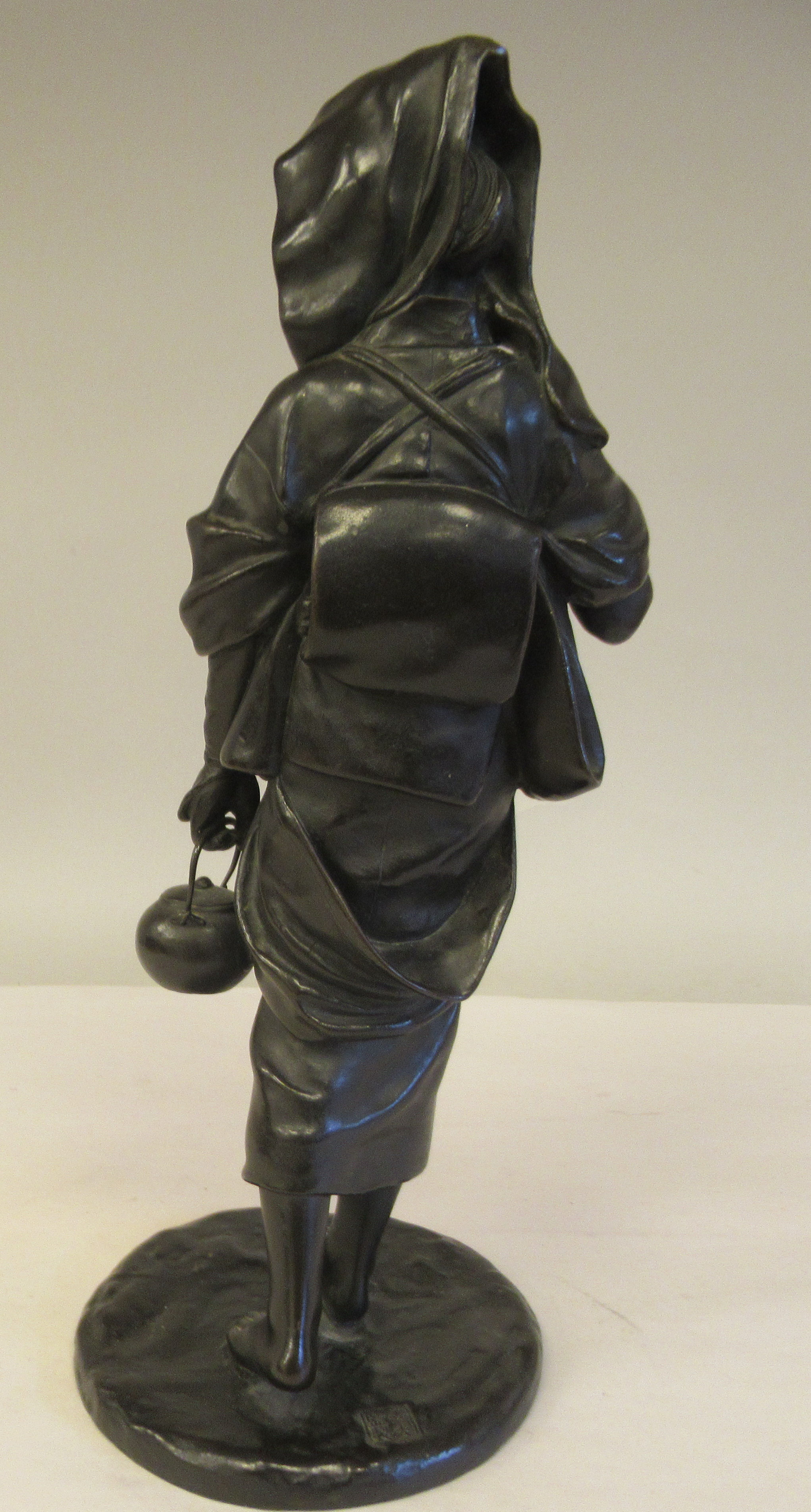 A late 19thC cast and patinated bronze figure, a young woman wearing traditional dress, walking with - Image 4 of 6