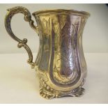 A mid Victorian silver Christening mug of waisted form with a double C-scrolled handle and bright
