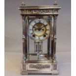 An early 20thC Ansonia Earl silver plated, four glass mantel clock with an ornately cast case,