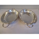 An Edwardian silver oval entrée dish and cover with opposing loop handles, applied wire rims and