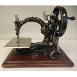 A vintage Willcox & Gibbs manual sewing machine, on a mahogany platform  boxed