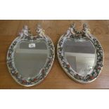 A pair of late 19thC Continental porcelain framed heart shaped mirrors, each surmounted by