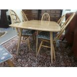 An Ercol blonde elm dining table, raised on five square, tapered legs  27"h  60"dia extending to