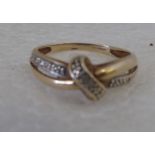 A 9ct gold and diamond set, entwined ring