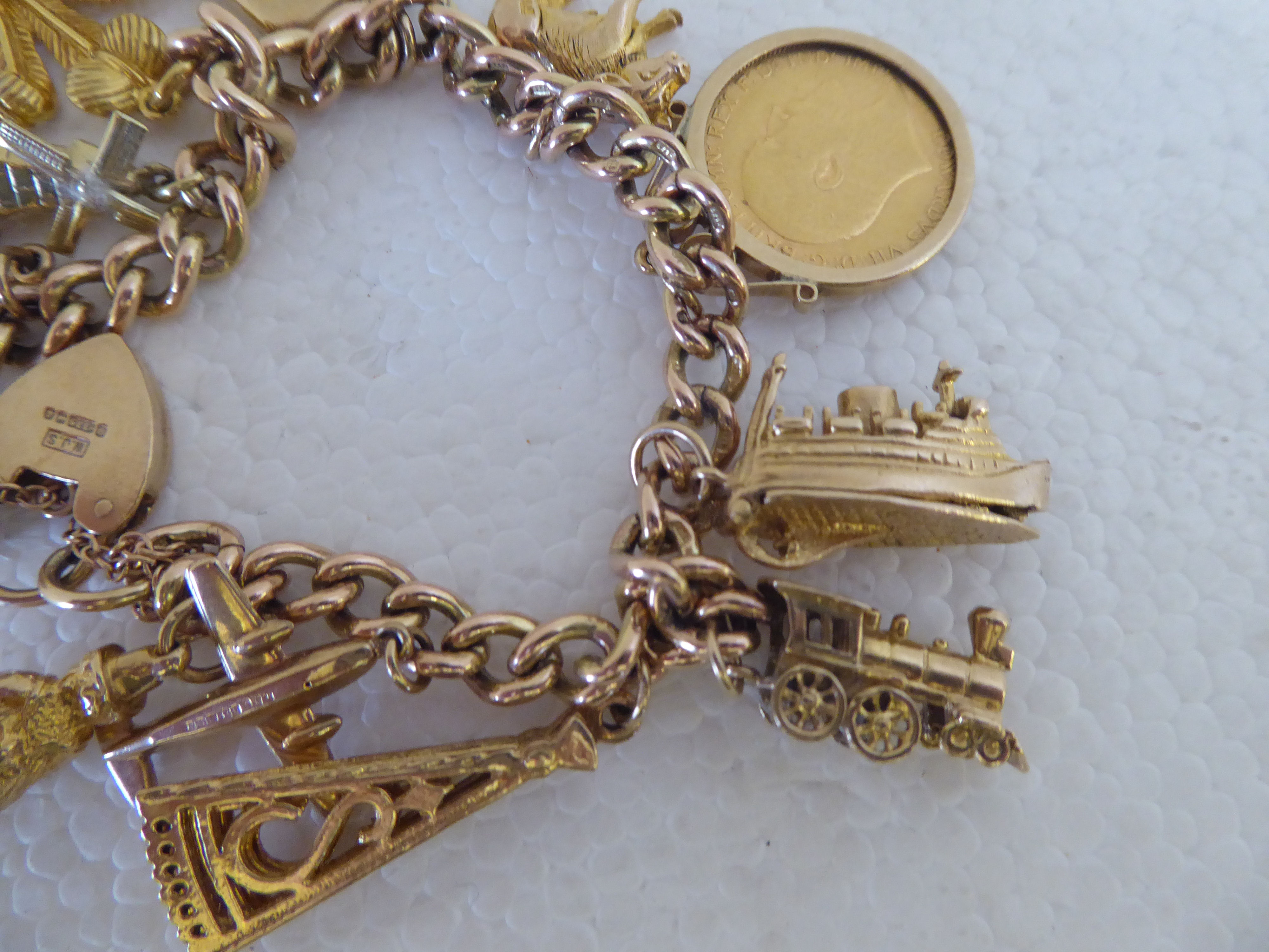 A 9ct gold bracelet with eleven 9ct gold and yellow metal charms; and an Edward VII half- - Image 2 of 4