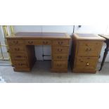 A modern pine, twin pedestal, nine drawer desk, on a plinth  30"h  48"w; and a matching two drawer