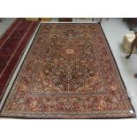 A Persian part silk woven rug, profusely decorated with floral and foliage designs in bright
