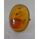 A 9ct gold, oval amber set ring