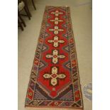 A Caucasian runner, decorated with six central motifs, on a multi-coloured ground  30" x 110"