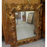 A 20thC mirror, the shaped plate in a moulded gilt frame  24.5" x 27"