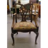 A George II oak splat back elbow chair, the later heraldic tapestry design fabric seat raised on