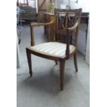 A reproduction of a Regency design hardwood, stencil painted elbow chair, decorated in Continental