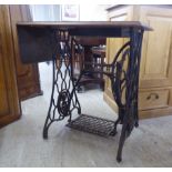 An early 20thC cast iron and oak Singer treadle sewing machine frame 29.5"h  30"w