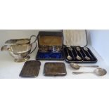Silver collectables: to include a pair of sauce boats; two cigarette cases; napkin rings; and spoons