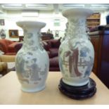 A pair of Lladro porcelain Chinese design vases, each decorated with figures in landscape