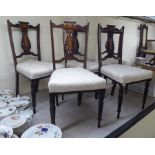 A set of five Edwardian string inlaid rosewood finished pierced splat back dining chairs with a