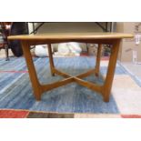 An Ercol blonde elm coffee table, raised on tapered legs with crossover stretchers  19"h  29"w