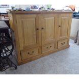 A Clive Cowell Bespoke Furniture Maker oak sideboard with three doors, over three drawers, on a