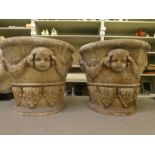 A pair of composition stone terrace planters, decorated with mask ornaments  13"h  16"dia