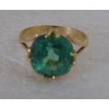 An 18ct gold, claw set, green stone dress ring