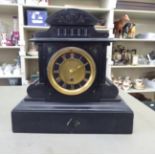 A late Victorian black slate cased mantel clock; the movement faced by a Roman dial  13"h