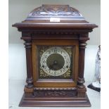 A late 19thC walnut cased mantel clock of architectural form; the 8 day Westminster chime movement