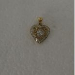 A gold coloured metal, open heart shape diamond set pendant