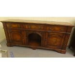 A modern traditional Old English style stained oak dresser with three frieze drawers, an open centre