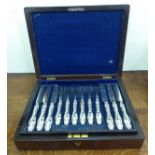 A set of eighteen Victorian silver plated fruit knives and forks, on scroll moulded silver handles