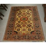 A Persian rug, decorated with repeating designs, on a multi-coloured ground  52" x 63"
