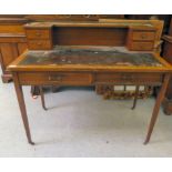 An Edwardian string inlaid mahogany desk with an inverted breakfront, four drawer gallery, over