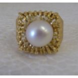 A 22ct gold, part textured ring, set with a single pearl