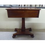 A late Victorian mahogany side table with a hinged lid, over a single drawer, raised on a pedestal