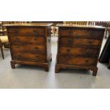A pair of modern walnut bedside chests with four graduated drawers, raised on bracket feet  30"h